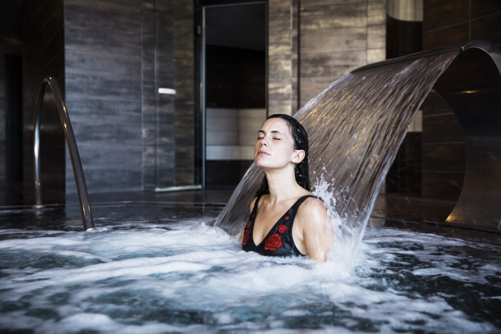 spa concept with woman relaxing water